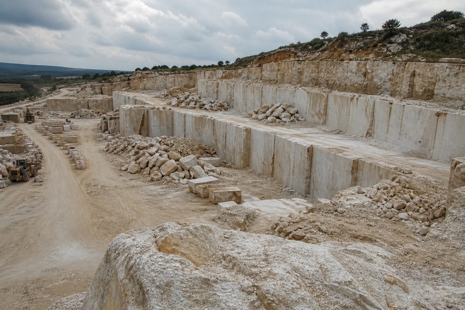 Limestone quarry benches in Central Portugal with extracted blocks ready for selection