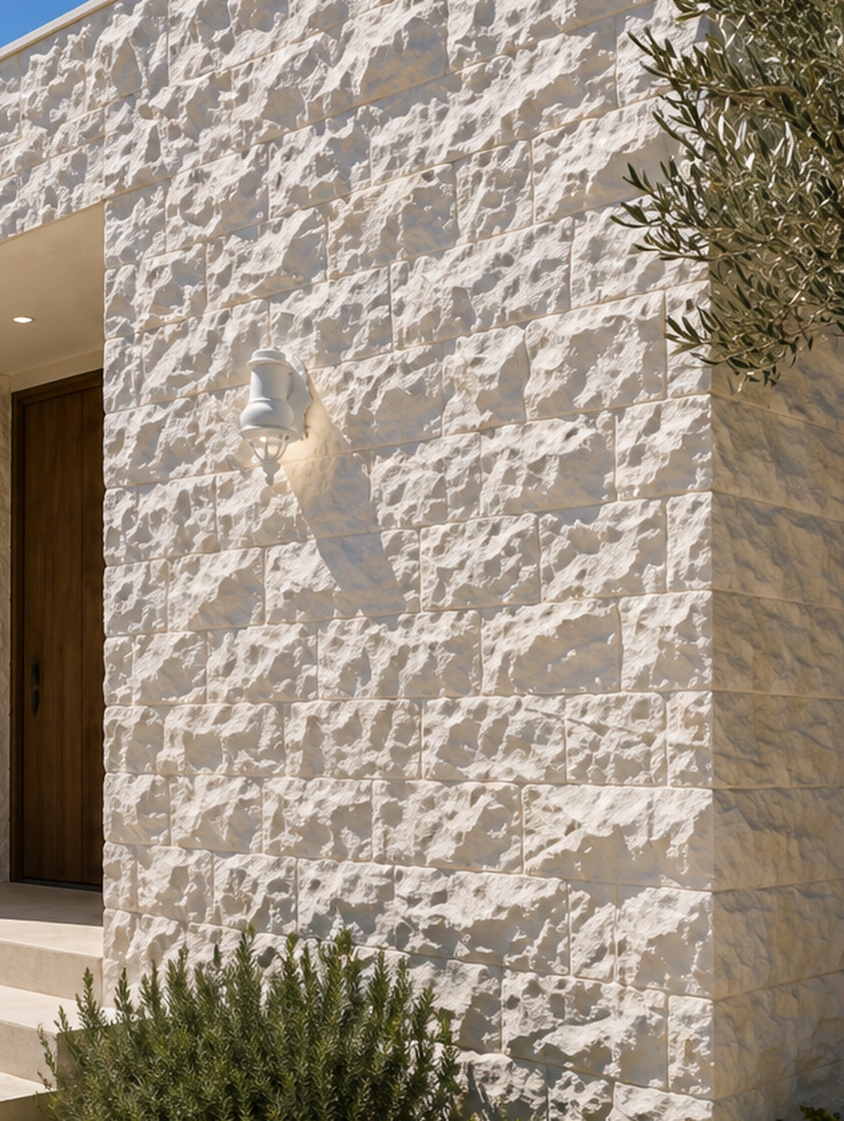 Hand-chiseled Luminous Ivory limestone wall cladding showing a textured, tonal stone surface
